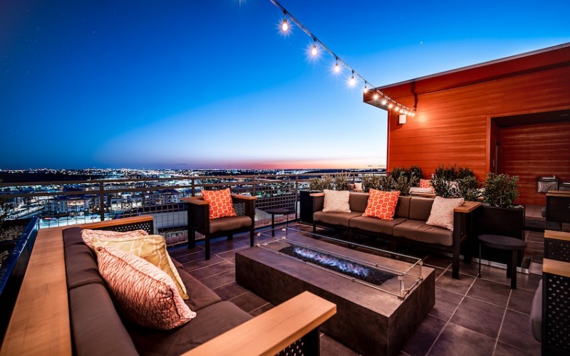 Outdoor fire pit with plenty of seating overlooking the city 