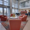 Spacious and well lit lobby with plenty of seating at large windows
