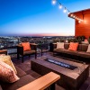 Large rooftop deck with plenty of seating and a view of the city 